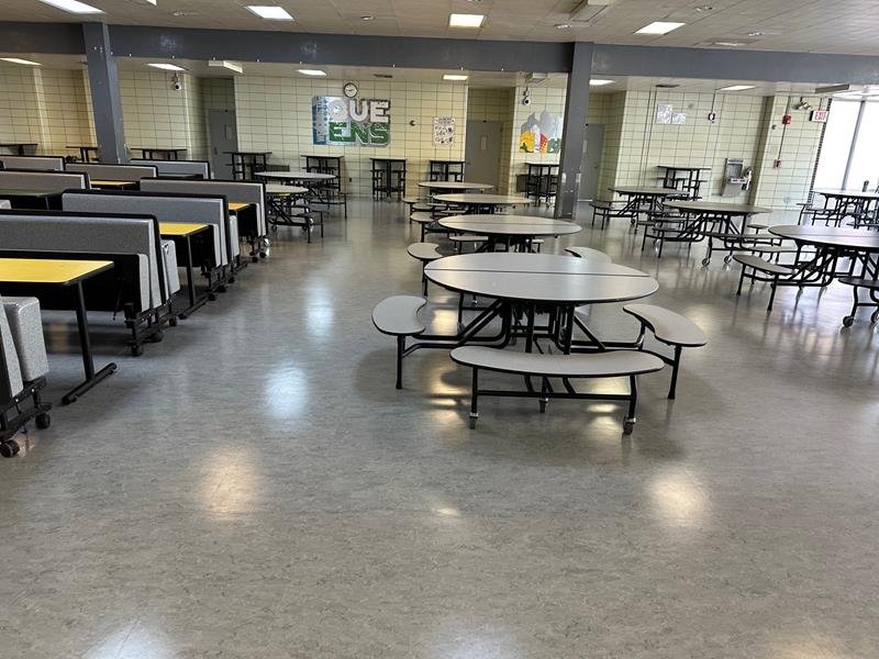 Cafeteria with long table rows and round tables